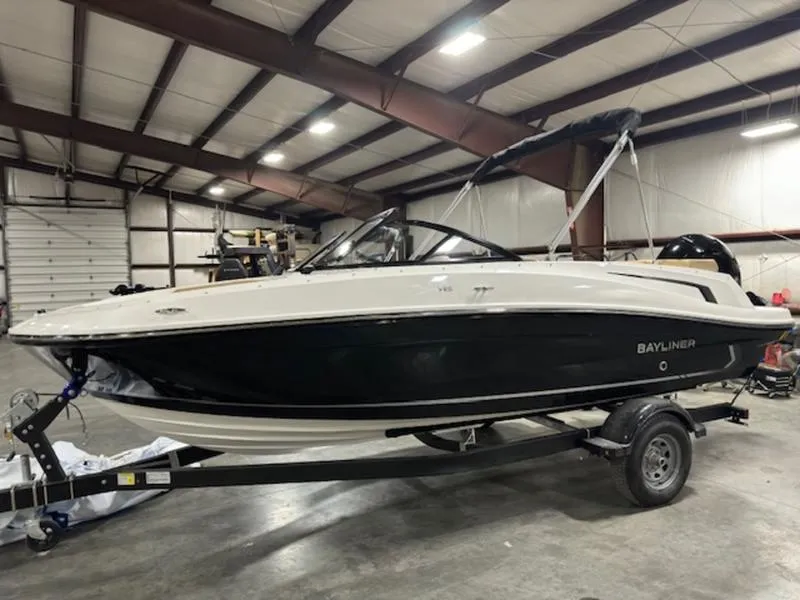 The Image of 2024 Bayliner VR5 Bowrider OB in a warehouse, on a trailer, side view. - 1