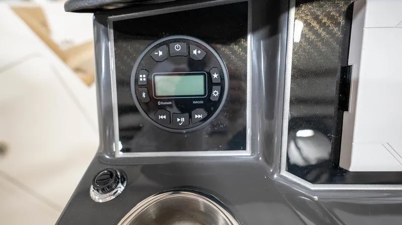Slide: The Image of 2024 Bayliner VR5 Bowrider OB dashboard with modern audio controls and cup holder. - 12
