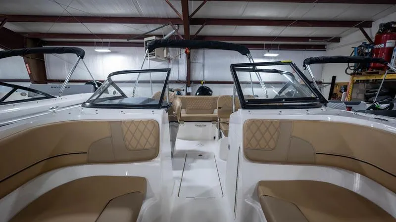 Slide: The Image of 2024 Bayliner VR5 Bowrider OB interior with tan seating and open cockpit design. - 16