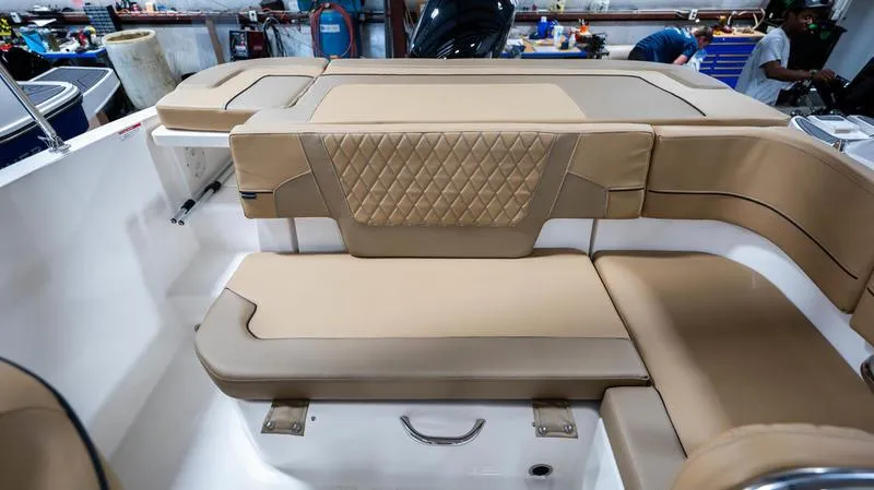Slide: The Image of 2024 Bayliner VR5 Bowrider OB interior with tan seating and diamond-patterned upholstery. - 19