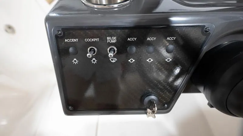 Slide: The Image of Control panel of 2024 Bayliner VR5 Bowrider OB with switches for accent, cockpit, and bilge pump. - 22