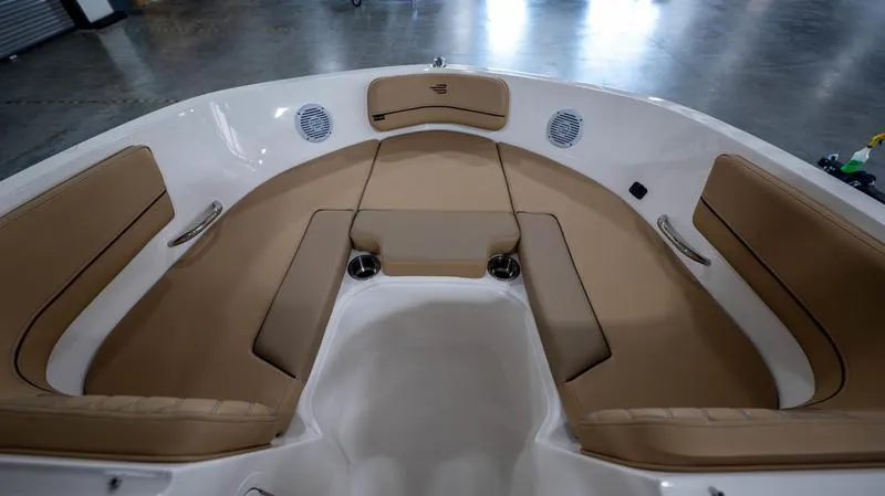 Slide: The Image of 2024 Bayliner VR5 Bowrider OB interior with tan seating and cup holders. - 23