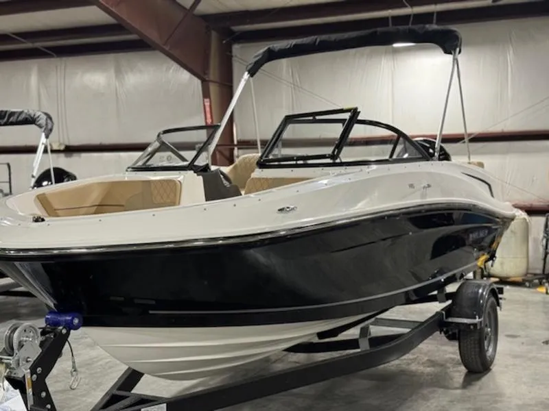 Slide: The Image of 2024 Bayliner VR5 Bowrider OB in a showroom, featuring sleek black and white design. - 3
