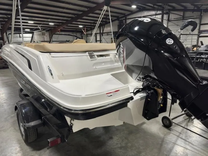 Slide: The Image of 2024 Bayliner VR5 Bowrider OB in a showroom, featuring a powerful outboard motor. - 4