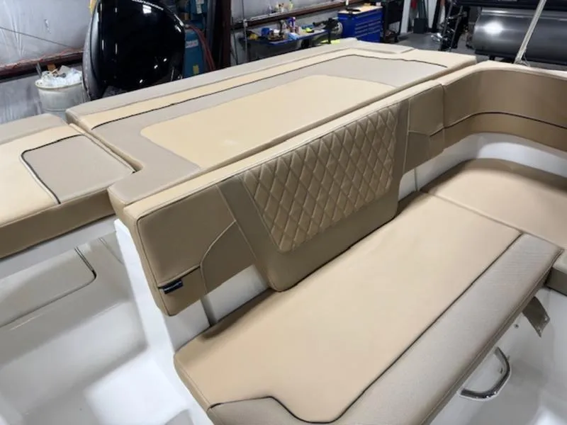 Slide: The Image of 2024 Bayliner VR5 Bowrider OB interior with beige cushioned seating. - 6