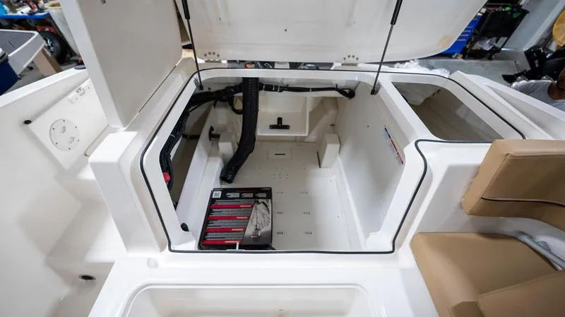 Slide: The Image of 2024 Bayliner VR5 Bowrider OB storage compartment with open hatch, showcasing interior space. - 8
