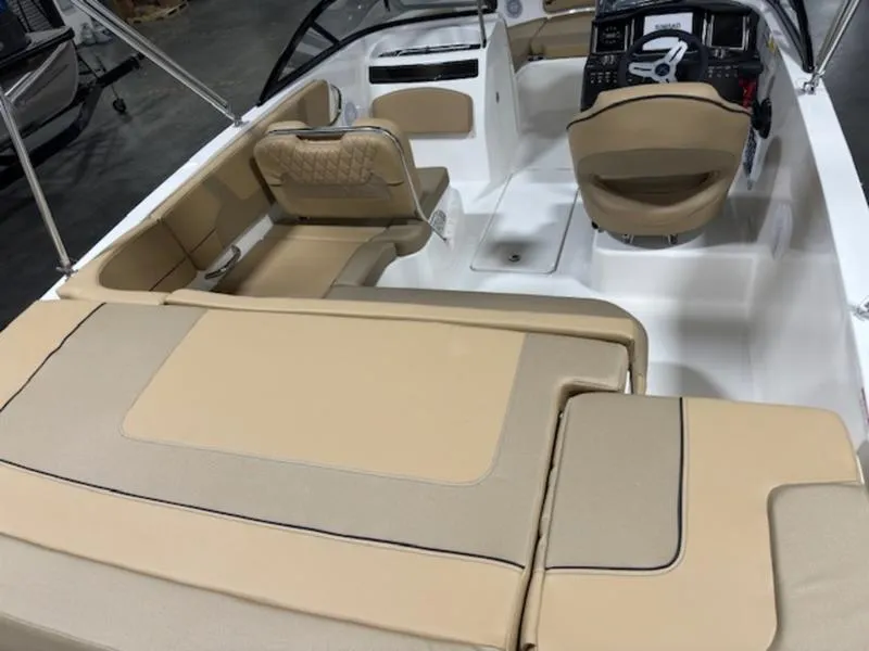 Slide: The Image of 2024 Bayliner VR5 Bowrider OB interior with beige seating and modern dashboard. - 9