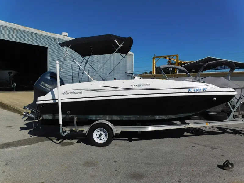Slide: The Image of 2014 Hurricane Sport 188 boat on trailer with Yamaha outboard motor. - 0