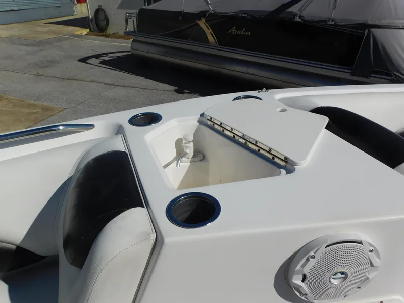 Slide: The Image of 2014 Hurricane Sport 188 boat interior with storage compartment and cup holders. - 10