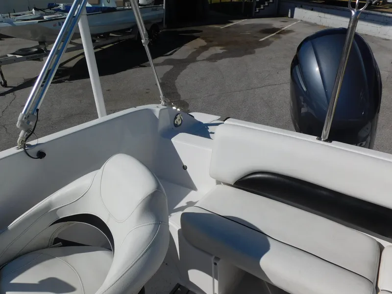 Slide: The Image of 2014 Hurricane Sport 188 boat interior with white seating and outboard motor. - 14