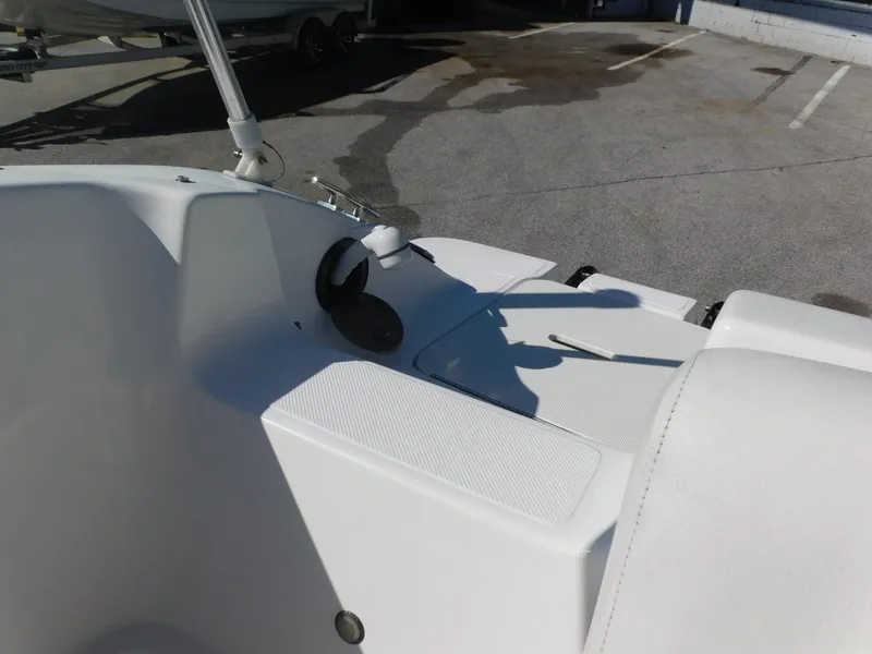 Slide: The Image of 2014 Hurricane Sport 188 boat interior detail with white seating and control panel. - 15