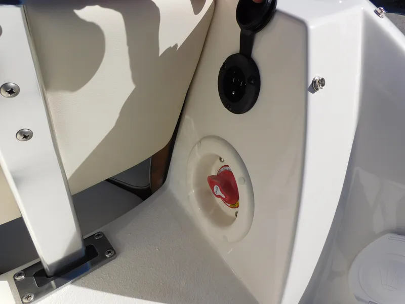 Slide: The Image of 2024 Stingray 231 DC boat interior detail with seat and control panel. - 10
