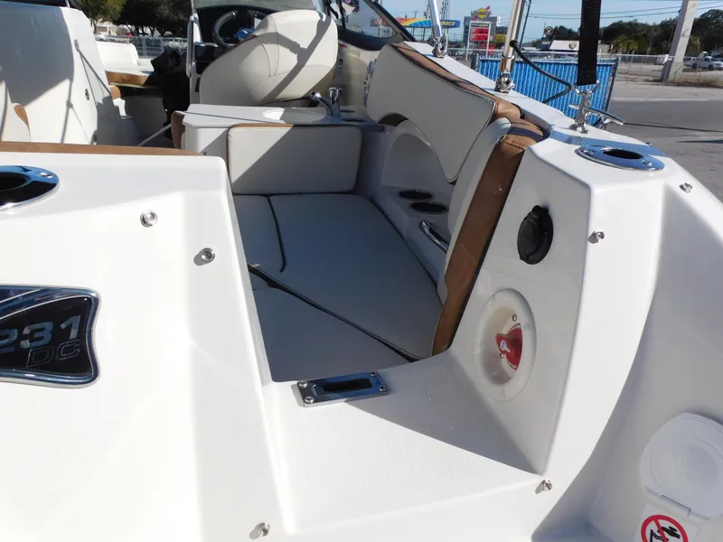 Slide: The Image of 2024 Stingray 231 DC boat interior with seating and control panel. - 11