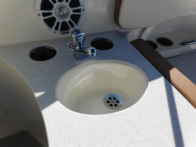 Slide: The Image of 2024 Stingray 231 DC boat sink and faucet with cup holders. - 13