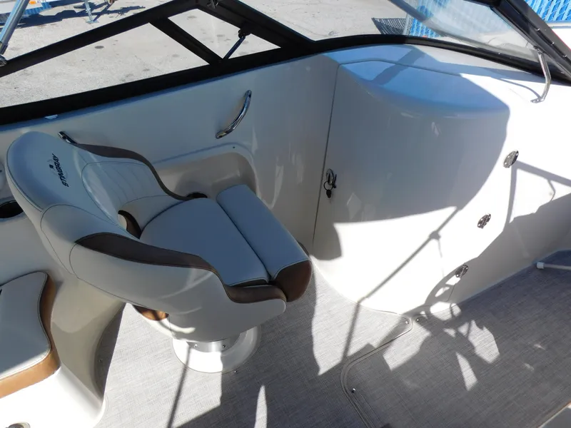 Slide: The Image of 2024 Stingray 231 DC boat interior with captain's chair and dashboard. - 15