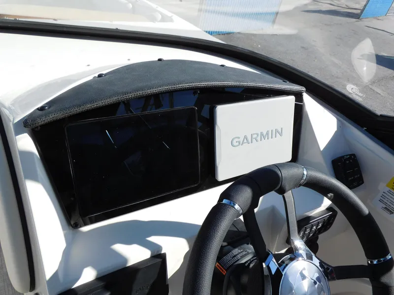 Slide: The Image of 2024 Stingray 231 DC boat dashboard with Garmin navigation system. - 17