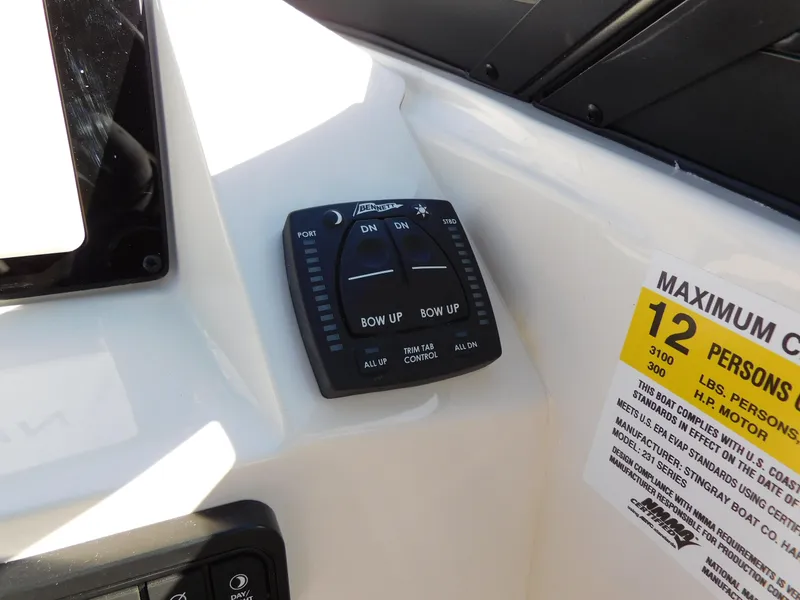 Slide: The Image of Control panel and capacity label on a 2024 Stingray 231 DC boat. - 21