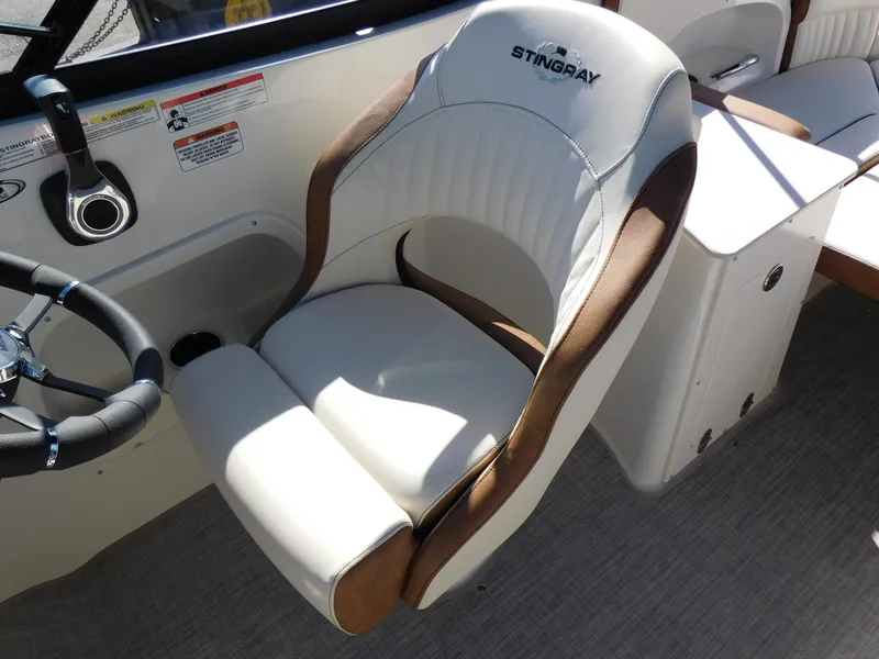 Slide: The Image of 2024 Stingray 231 DC boat captain's chair and steering wheel. - 23