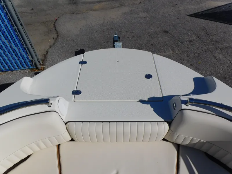 Slide: The Image of 2024 Stingray 231 DC boat bow seating area with white upholstery. - 30