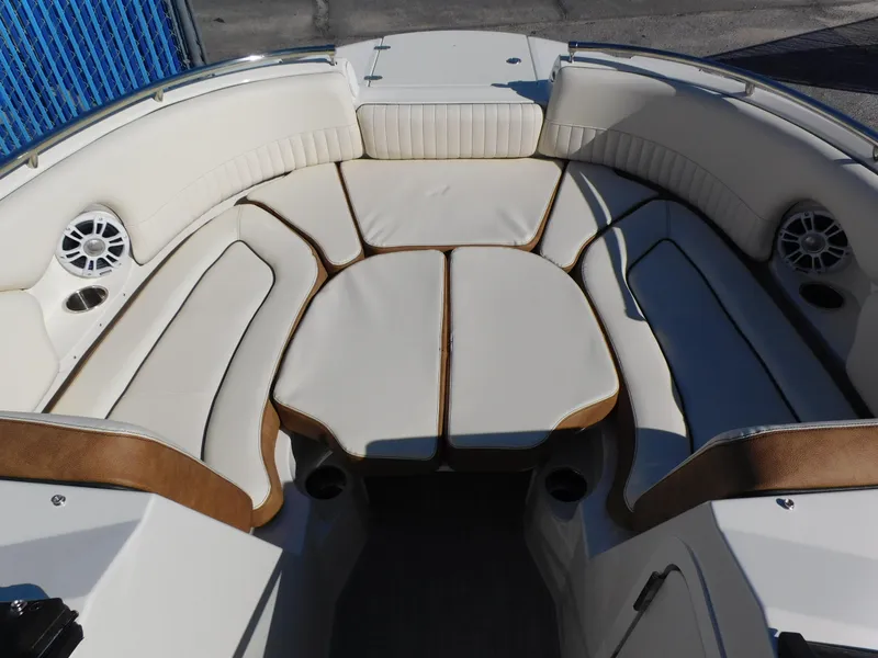 Slide: The Image of 2024 Stingray 231 DC boat with spacious, cushioned seating area. - 34