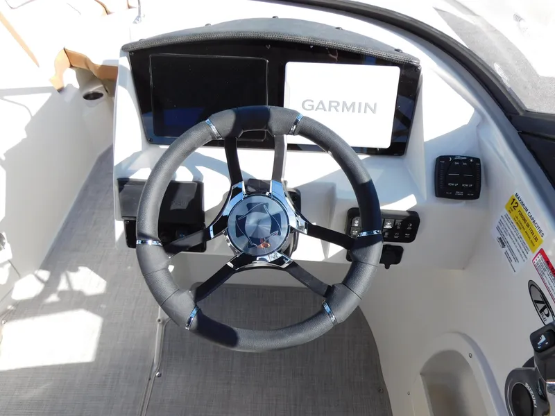 Slide: The Image of 2024 Stingray 231 DC boat dashboard with Garmin navigation system. - 35
