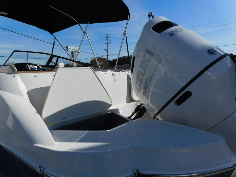 Slide: The Image of 2024 Stingray 231 DC boat with Suzuki outboard motor. - 7