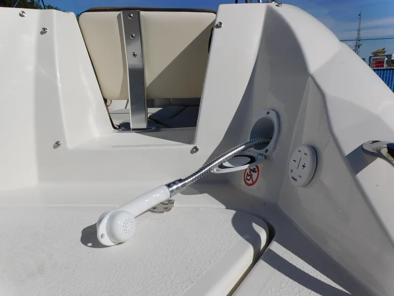 Slide: The Image of 2024 Stingray 231 DC boat deck with shower head and seating. - 8