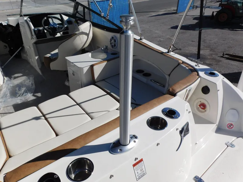Slide: The Image of 2024 Stingray 231 DC boat interior with seating and cup holders. - 9