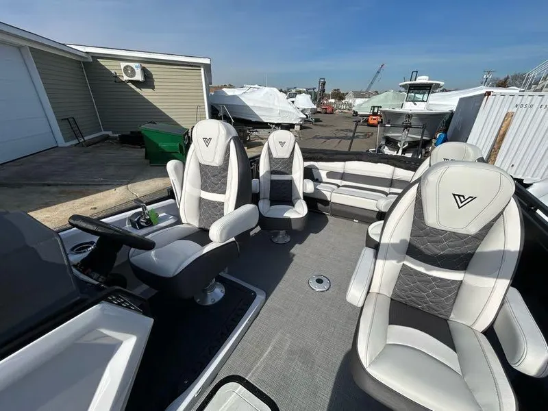 Slide: The Image of 2024 Viaggio d22q boat interior with luxurious seating at a marina. - 11