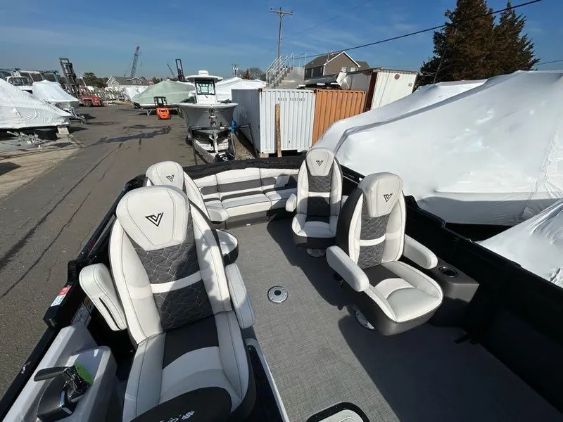 Slide: The Image of Viaggio d22q 2024 boat interior with luxurious seating at a marina. - 12