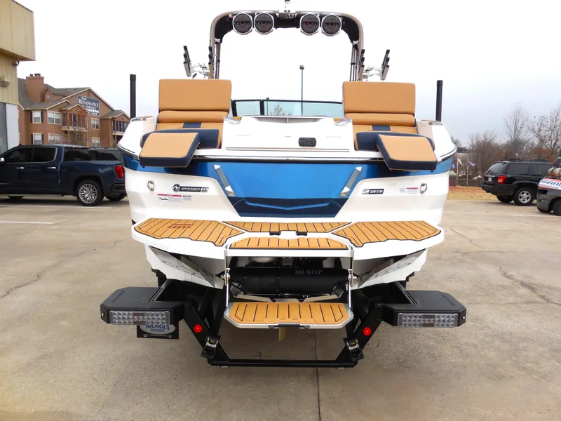 Slide: The Image of 2024 MasterCraft X26 boat rear view with teak swim platform and seating. - 4