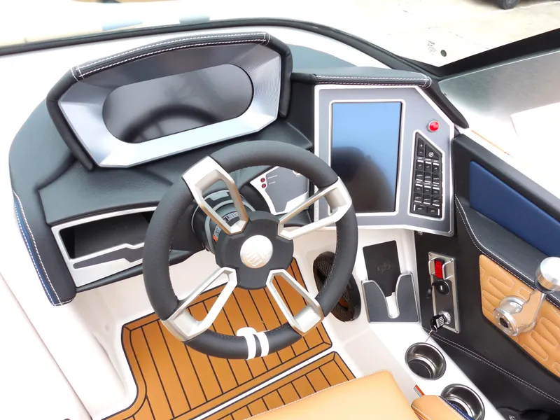 Slide: The Image of 2024 MasterCraft X26 boat dashboard with modern steering wheel and touchscreen controls. - 7