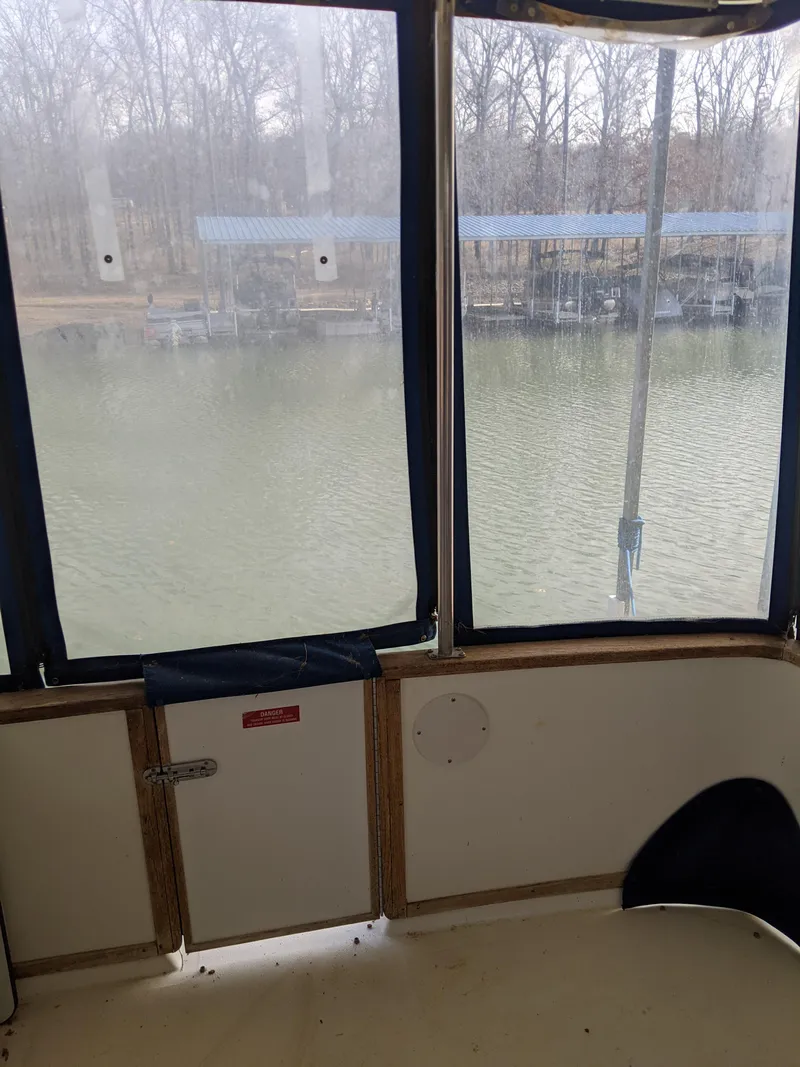 Slide: The Image of View from the 1989 Sea Ray 380 Aft Cabin, overlooking a serene marina. - 11