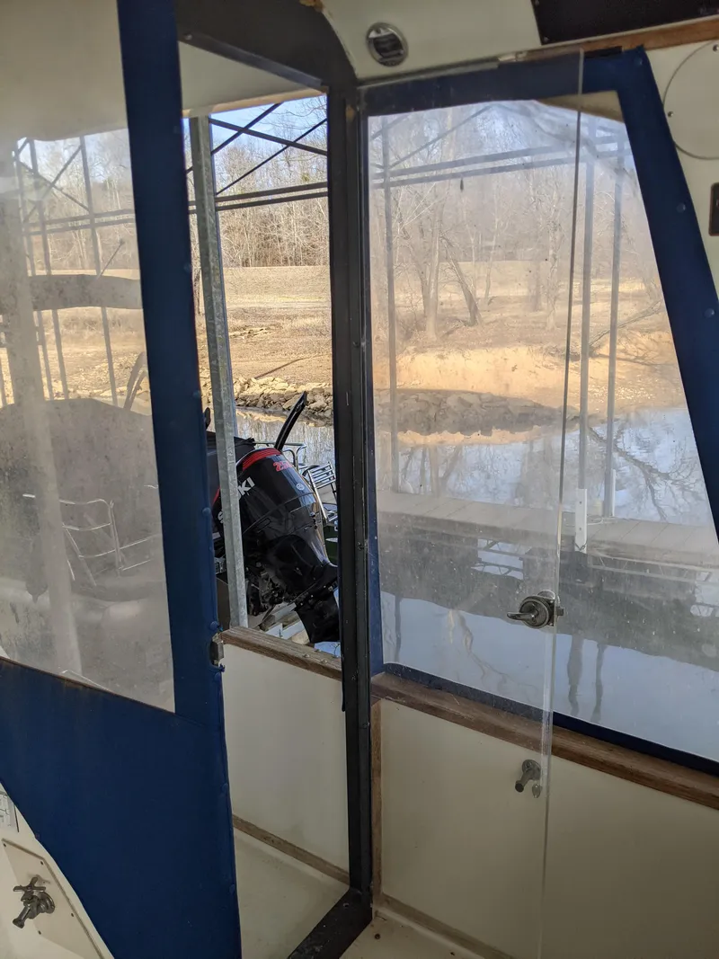 Slide: The Image of 1989 Sea Ray 380 Aft Cabin interior view with clear windows and outdoor scenery. - 12