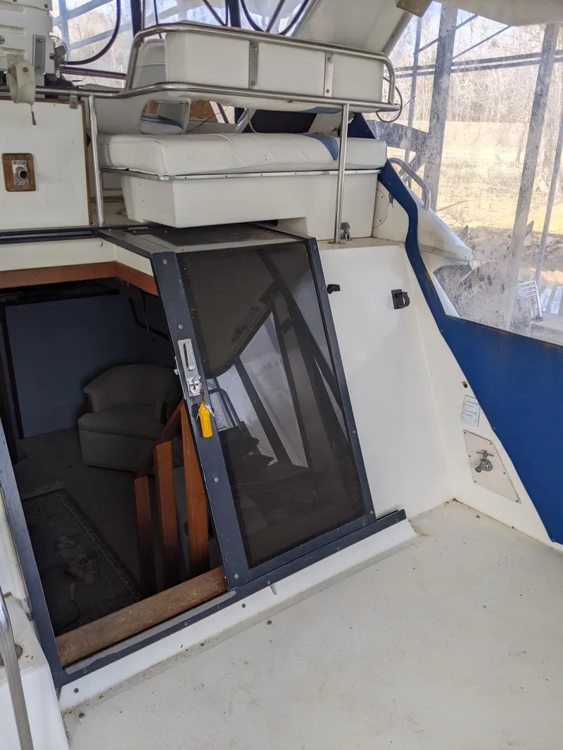 Slide: The Image of 1989 Sea Ray 380 Aft Cabin interior with seating and cabin entrance. - 13