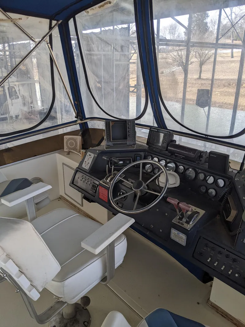 Slide: The Image of 1989 Sea Ray 380 Aft Cabin boat helm with steering wheel and navigation equipment. - 17