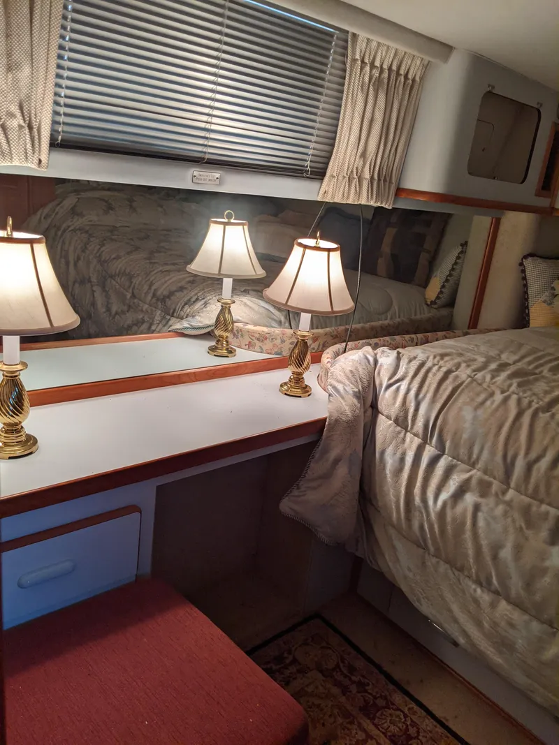 Slide: The Image of Cozy bedroom interior of 1989 Sea Ray 380 Aft Cabin yacht with lamps and mirror. - 21