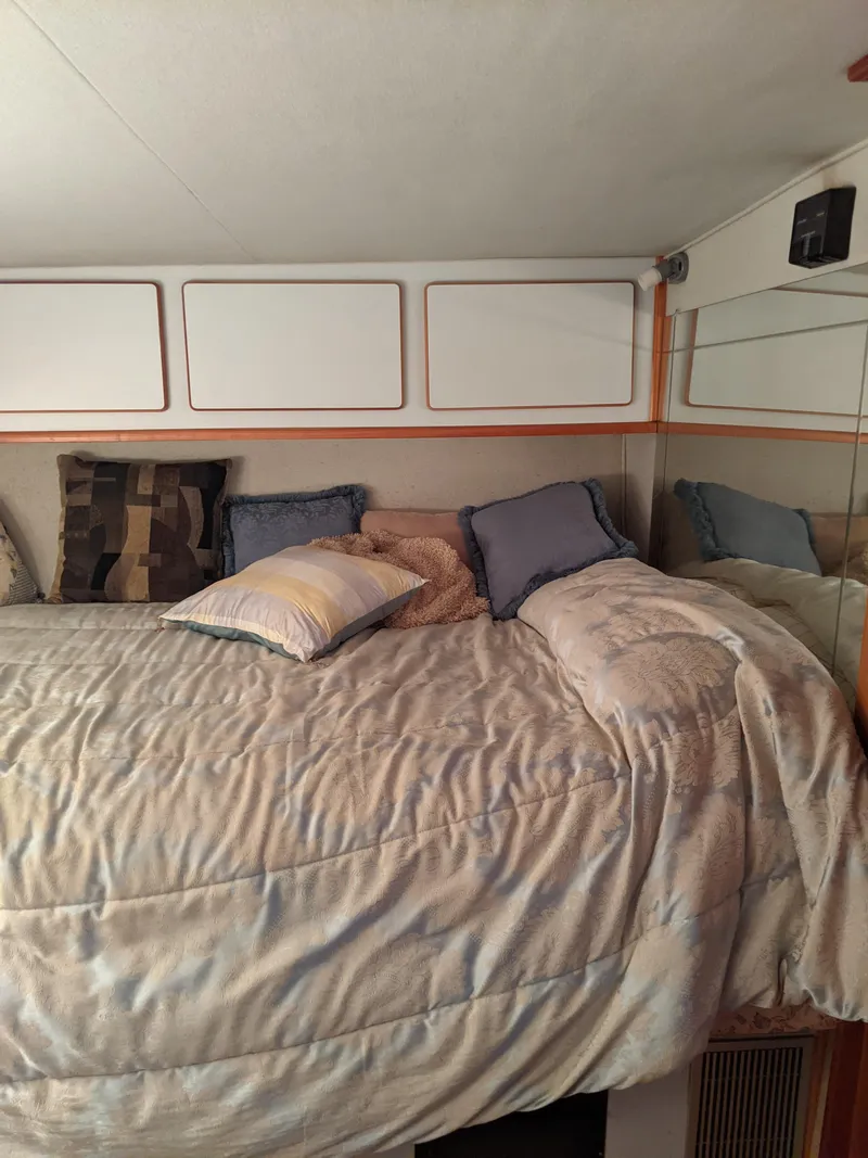 Slide: The Image of Cozy bedroom in 1989 Sea Ray 380 Aft Cabin yacht with plush bedding and pillows. - 22