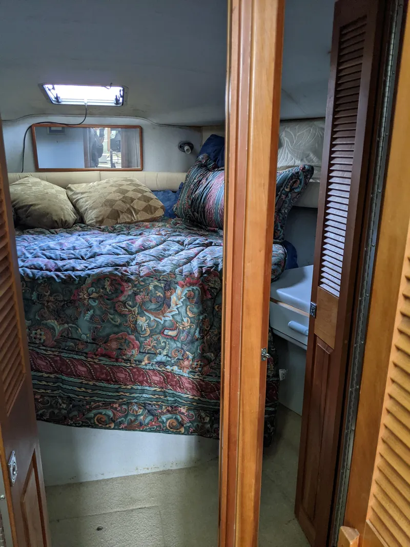 Slide: The Image of Cozy bedroom in 1989 Sea Ray 380 Aft Cabin yacht with colorful bedding. - 28