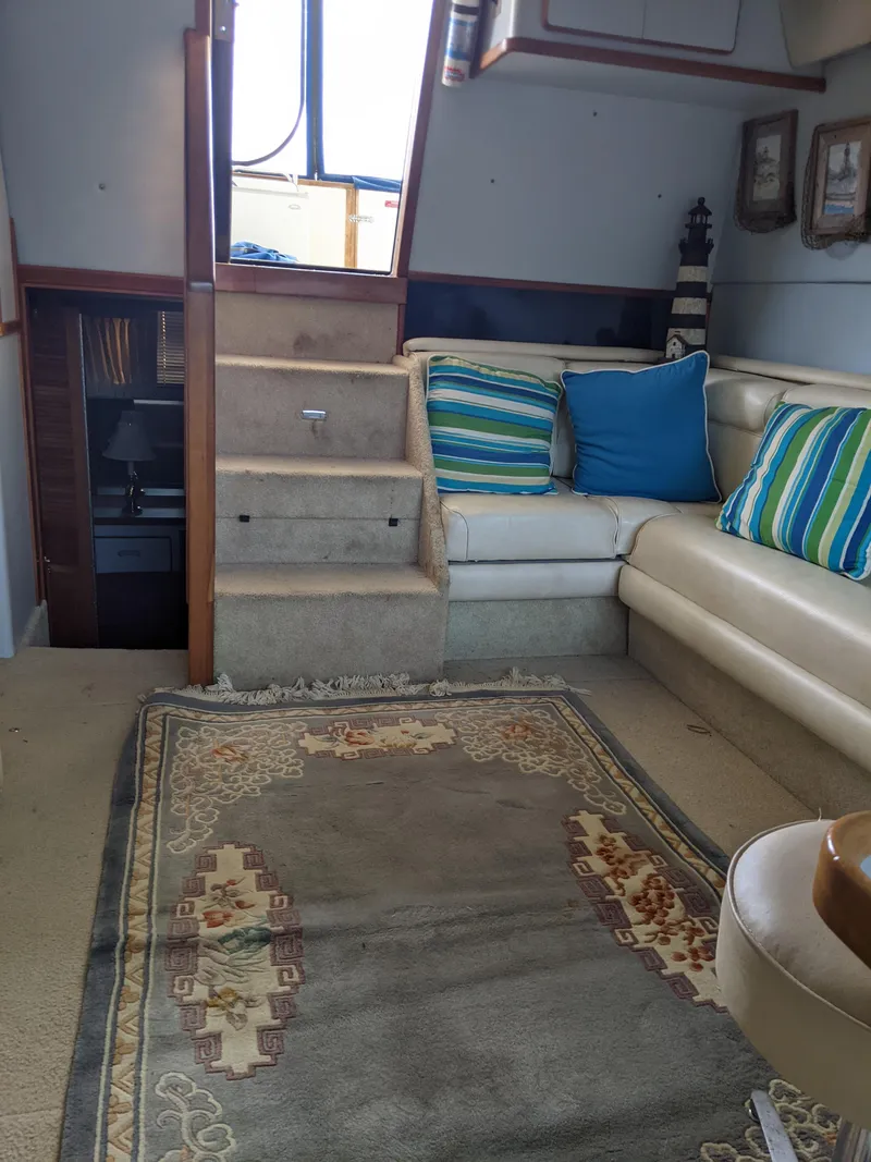 Slide: The Image of Interior of 1989 Sea Ray 380 Aft Cabin with carpet, sofa, and colorful cushions. - 36