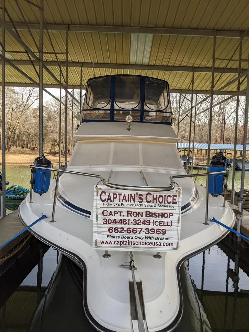 Slide: The Image of 1989 Sea Ray 380 Aft Cabin boat docked with Captain's Choice brokerage sign. - 4
