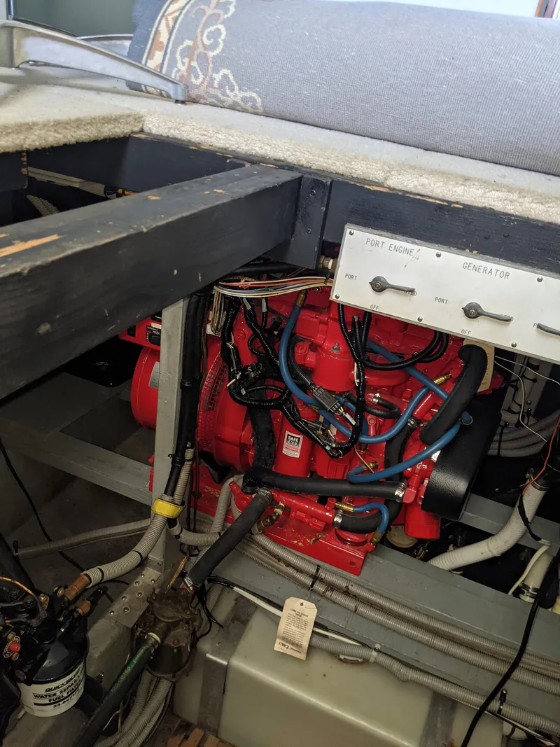 Slide: The Image of Engine compartment of a 1989 Sea Ray 380 Aft Cabin boat with visible red engine. - 45