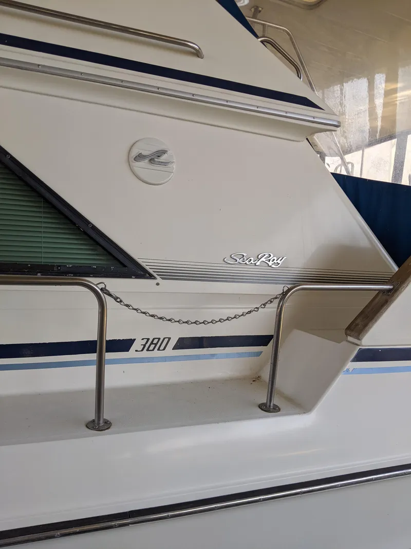 Slide: The Image of 1989 Sea Ray 380 Aft Cabin yacht exterior with railing and logo. - 47