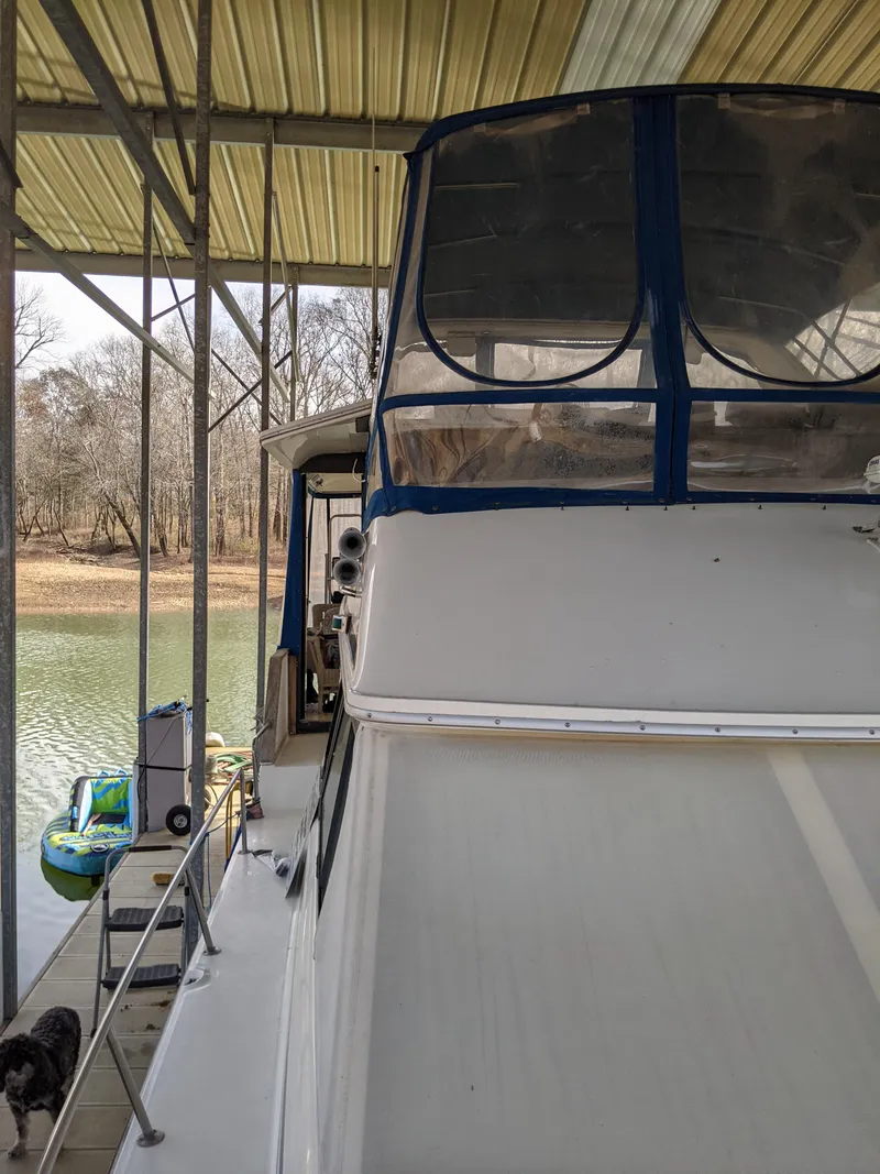 Slide: The Image of 1989 Sea Ray 380 Aft Cabin yacht docked under a covered marina. - 5