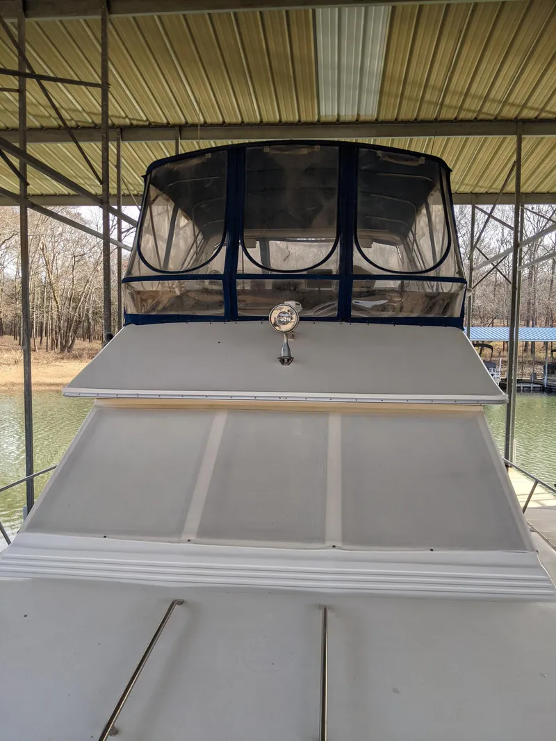 Slide: The Image of 1989 Sea Ray 380 Aft Cabin boat docked under a covered marina. - 6