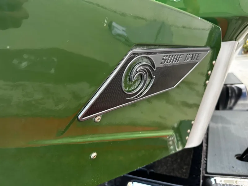 Slide: The Image of 2021 Axis T22 boat with Surf Gate logo on green hull. - 10
