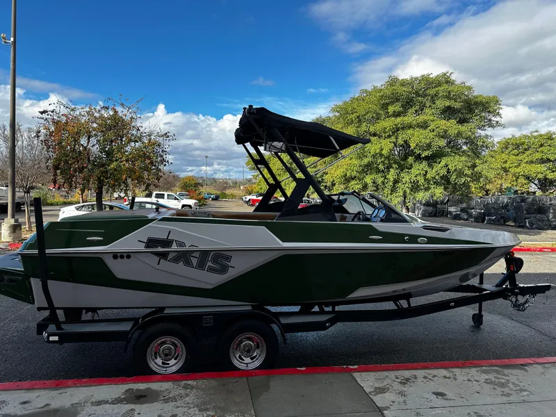 Slide: The Image of 2021 Axis T22 boat on a trailer, parked outdoors on a sunny day. - 12