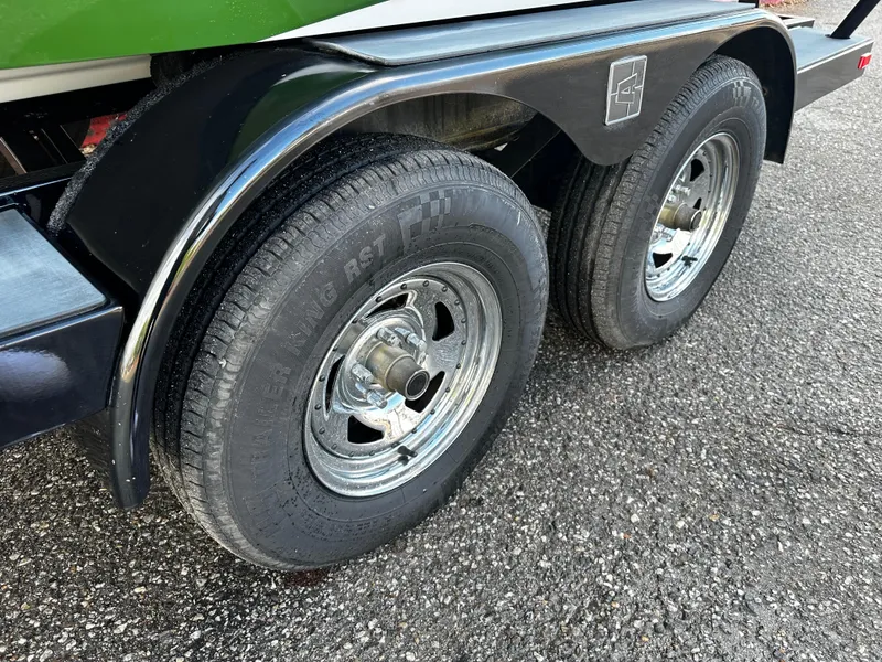 Slide: The Image of Close-up of 2021 Axis T22 trailer wheels on asphalt. - 16