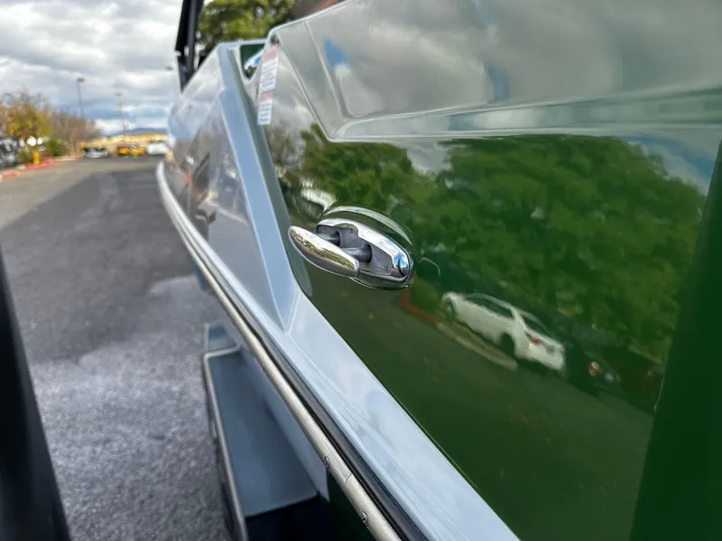 Slide: The Image of 2021 Axis T22 boat side view with green and white exterior. - 17