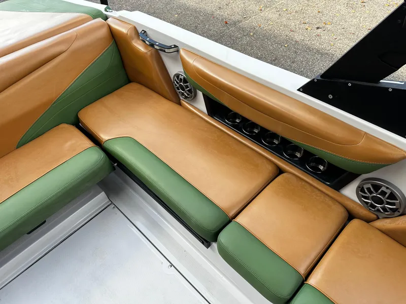 Slide: The Image of 2021 Axis T22 boat interior with tan and green seating. - 24